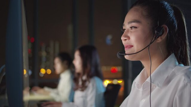 Group asia telesale people, Covid mental health care contact hotline or CRM global sale agent telework staff answering client phone smile talk advice in stock trade at late night work job at office.