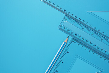 A picture of geometry set with sticky note on copyspace blue background. Mathematics and engineering concept