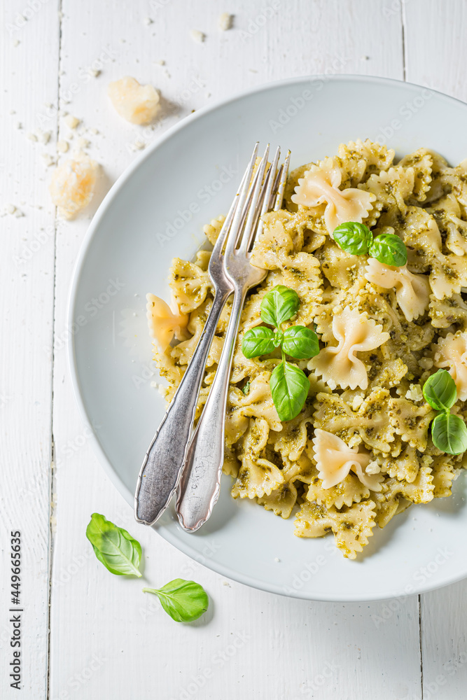 Wall mural farfalle pasta with green pesto and basil.