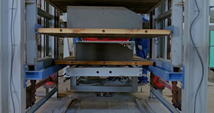 Modern logistics in production, warehouse equipment. Shelves with concrete parts are installed on a stacker, plant equipment. 4k, ProRes