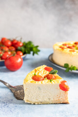 Piece of savoury tomato cheesecake with herbs decorated mint, blue concrete background.