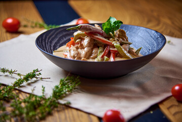 salad of vegetables, meat, filled with sauce