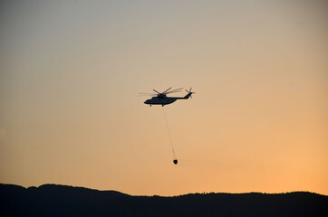 Russian  helicopter draws water from the sea to extinguish a forest fire. Marmaris,Turkey