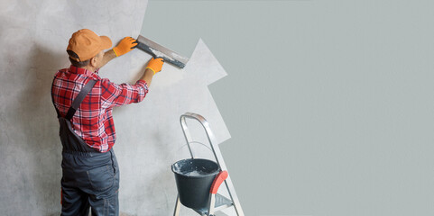 Builder with a spatula, the process of applying a layer of putty. Renovation of apartments. Banner.