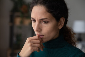 Fototapeta na wymiar Close up thoughtful upset woman thinking about personal or relationships problems alone, biting nail, frustrated depressed young female lost in thoughts, feeling lonely and sad, pondering