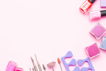A set of cosmetics for manicure and pedicure on a pink and purple background. Gel varnishes, nail...