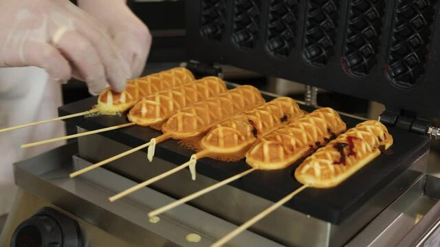 cook prepares waffles in the kitchen

