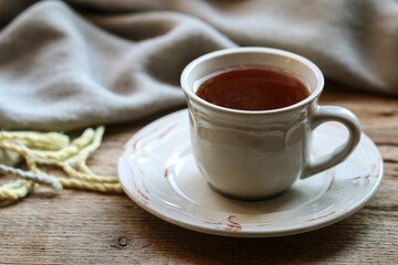 Porcelain cup of tea on a wooden table.