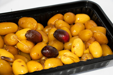Red And Yellow Dates Fruit In Black Container. White Background And Selective Focus