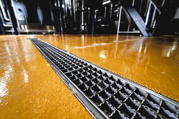 stainless steel floor drain at a modern beer factory - obrazy, fototapety, plakaty