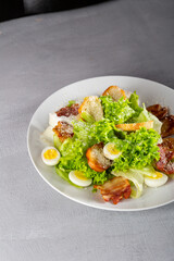 Close up of chicken, eggs and bacon salad on plate food