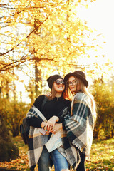 Naklejka premium two young girls walk around the city in the autumn city and park