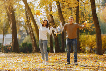 Fototapeta premium Cute and stylish family playing in a autumn field