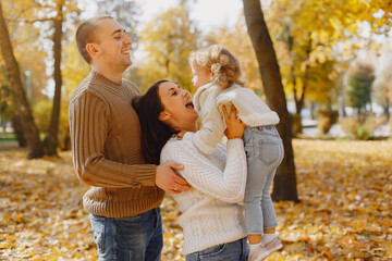 Fototapeta premium Cute and stylish family playing in a autumn field