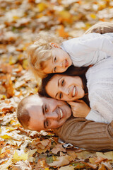 Cute and stylish family playing in a autumn field