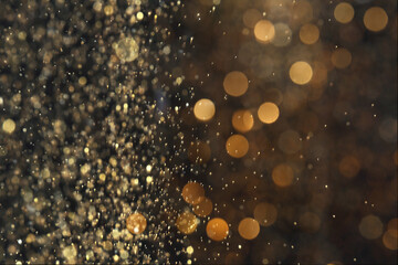 Blurred view of golden lights on black background. Bokeh effect