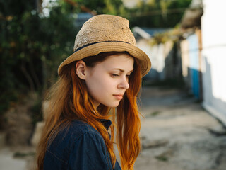 red-haired woman in hat outdoors sun walk leisure