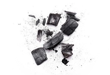 Close-up of pieces broken wooden coal, ash, black powder isolated on white. Top view