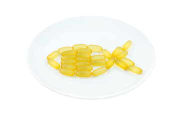 Fish oil capsules in the form of fish on a white plate. Isolated object. Omega 3, Vitamin D. Healthcare Concept. Healthy lifestyle