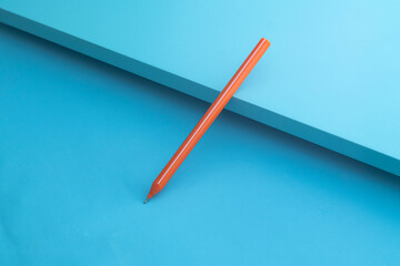 Orange Ballpoint on Blue background. Blue board