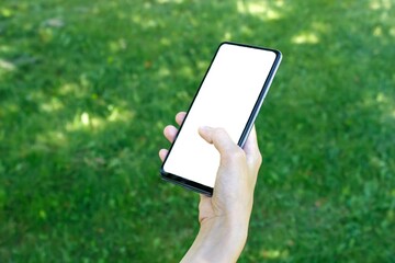 Woman holding cell phone with blank white screen.