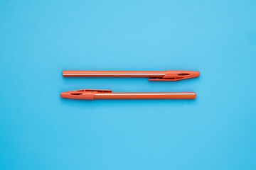 Orange Ballpoint on Blue background. Blue board