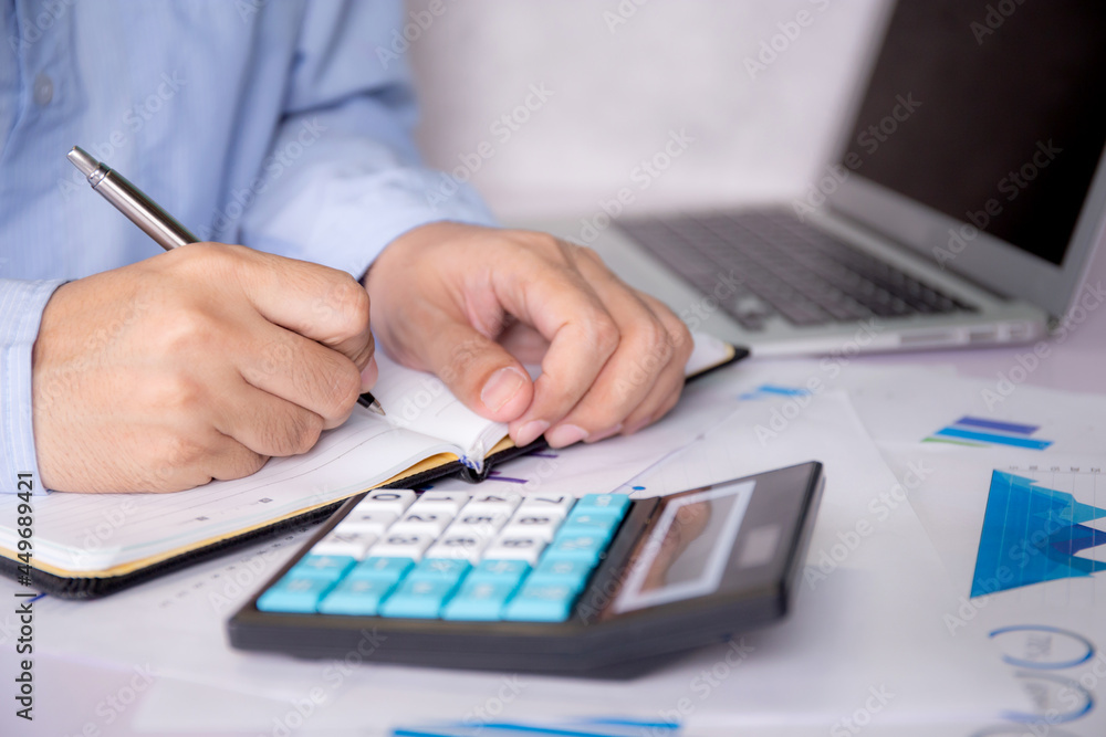 Poster hands of businessman calculate tax with calculator while laptop computer on desk, man planning finan