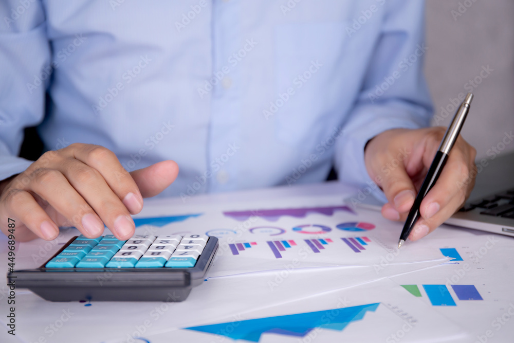 Aufkleber hands of businessman calculate tax with calculator while laptop computer on desk, man planning finan