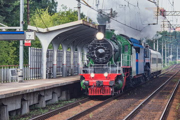 Retro train departs from the platform. Moscow region.
