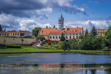 Naklejka na ściany i meble Pond in Barczewo town, view with City Hall building, Poland