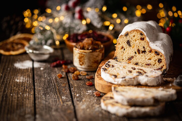 Christmas Stollen. Traditional Sweet Fruit Loaf with Icing Sugar. Xmas holiday table setting.