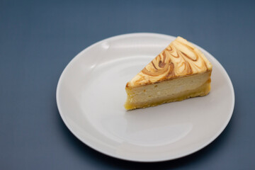 A piece of fresh tender caramel cheesecake on a plate