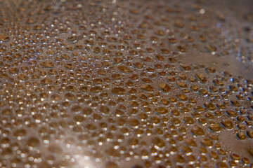 water drops from steam on the glass of the pan lid