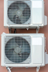 An outdoor air conditioner unit consisting of two fans. A large industrial air conditioner on the...