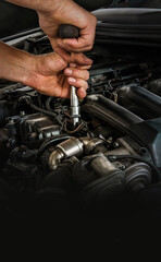 Auto mechanic working on car engine in mechanics garage. Repair service. Close-up shot. Free space...