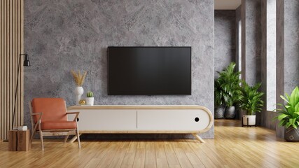Leather armchair and a wooden cabinet in living room interior with plant,TV on concrete wall.
