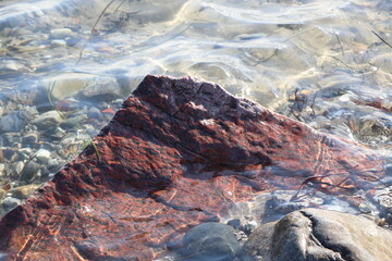 Red rock on the beach as a natural display