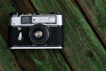 old photo camera on wooden background