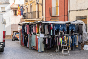Clothing market store set up in the square of a small town.