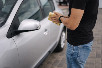 Middle selection on man hold yellow rug for car cleaning