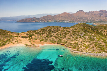 Fototapeta na wymiar Aerial view of the dry Greek coastline in summer (Elounda, Crete)
