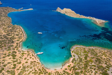 Fototapeta na wymiar Aerial view of an island surrounded by beautiful, clear blue ocean in summer (Kolokitha, Crete, Greece)