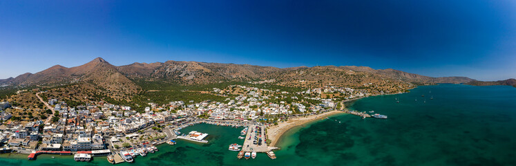 ELOUNDA, CRETE/GREECE - JULY 16 2021: Aerial view of the port and resort town of Elounda on the...
