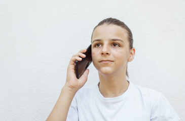 photo boy with a mobile phone in various poses, the concept of modern life, portrait isolated on white background 