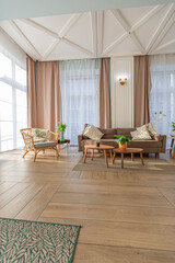 modern expensive luxurious open-plan apartment. Rich Scandinavian-style interior with wooden beams on the ceiling in pastel colors