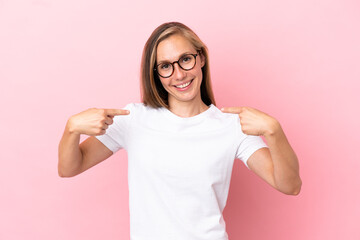 Young English woman isolated on pink background giving a thumbs up gesture