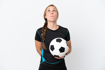 Young football player woman isolated on white background and looking up