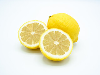 Lemon and lime, cut in half, white background