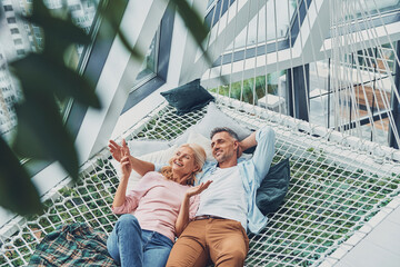 Top view of beautiful mature couple smiling and communicating