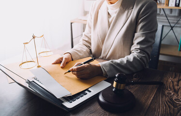 Justice and law concept.Male judge in a courtroom with the gavel, working with, computer and...